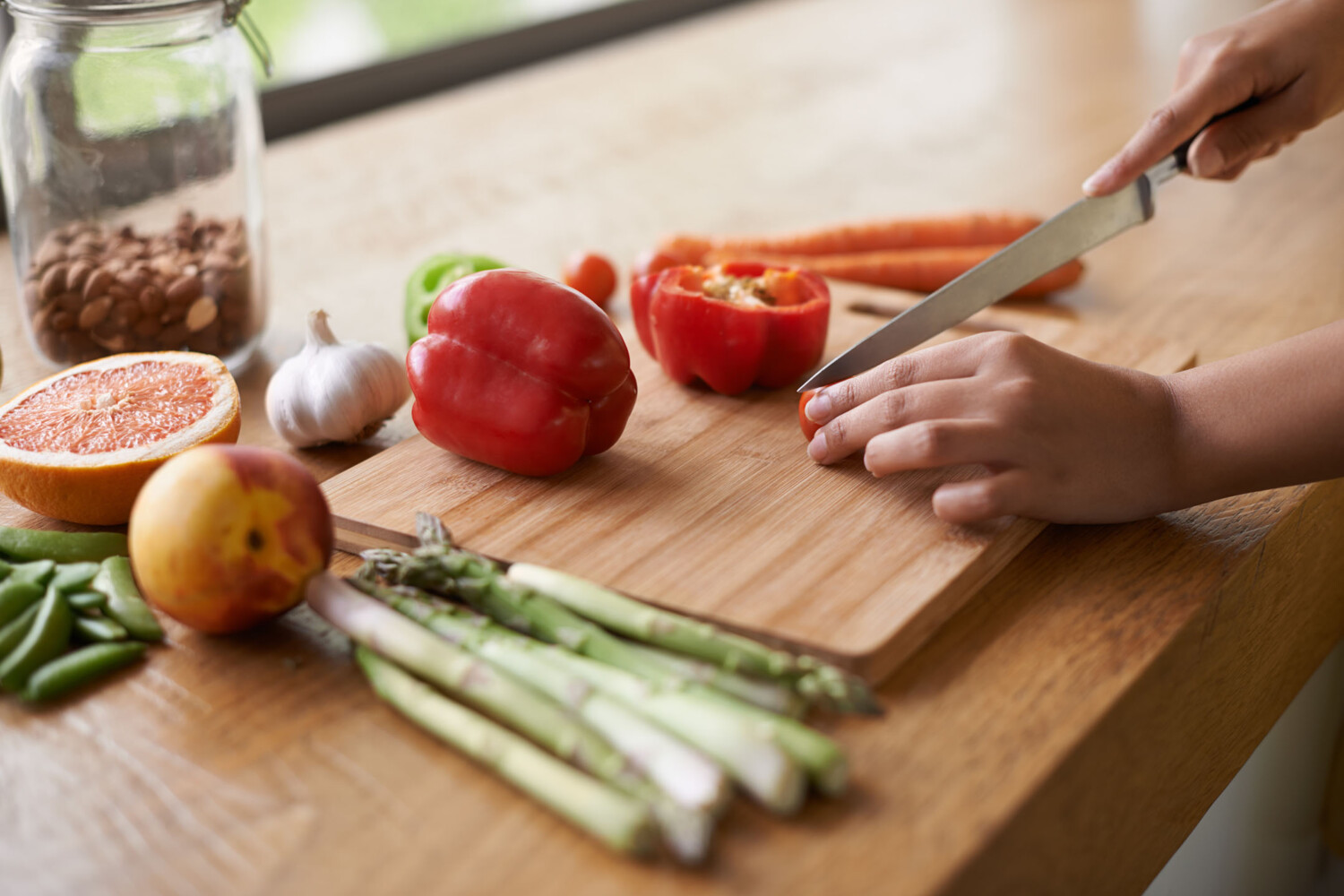 Close-up cropped image of a woman preparing food on a chopping board