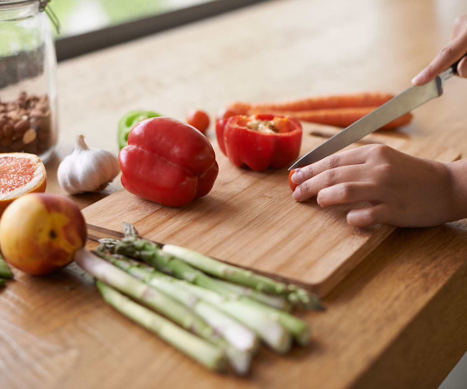 Close-up cropped image of a woman preparing food on a chopping board