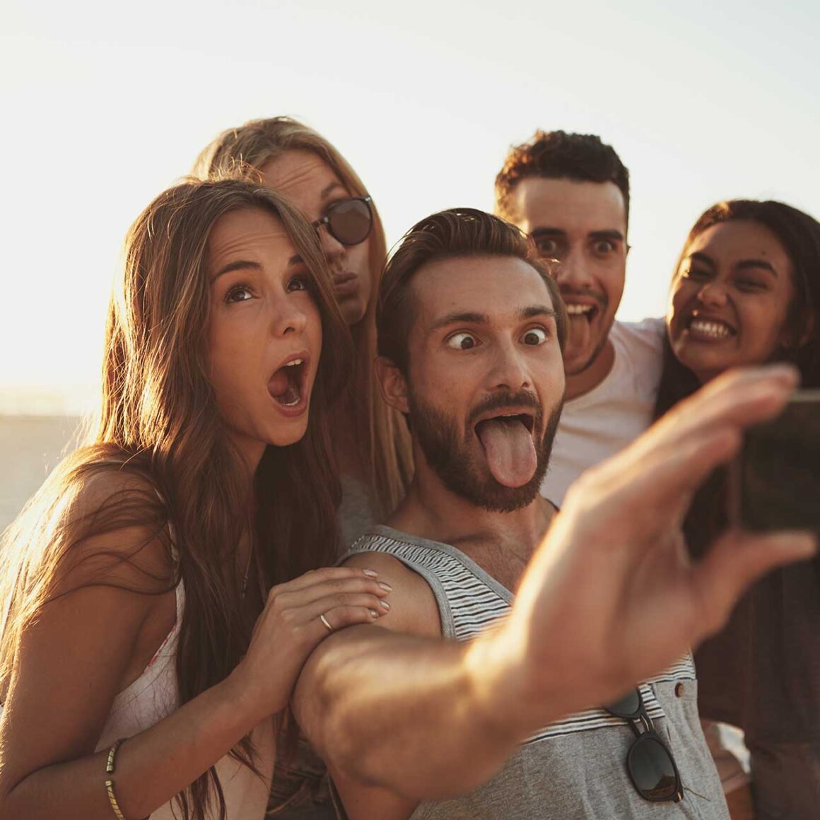 A group of friends taking a selfie on the beach