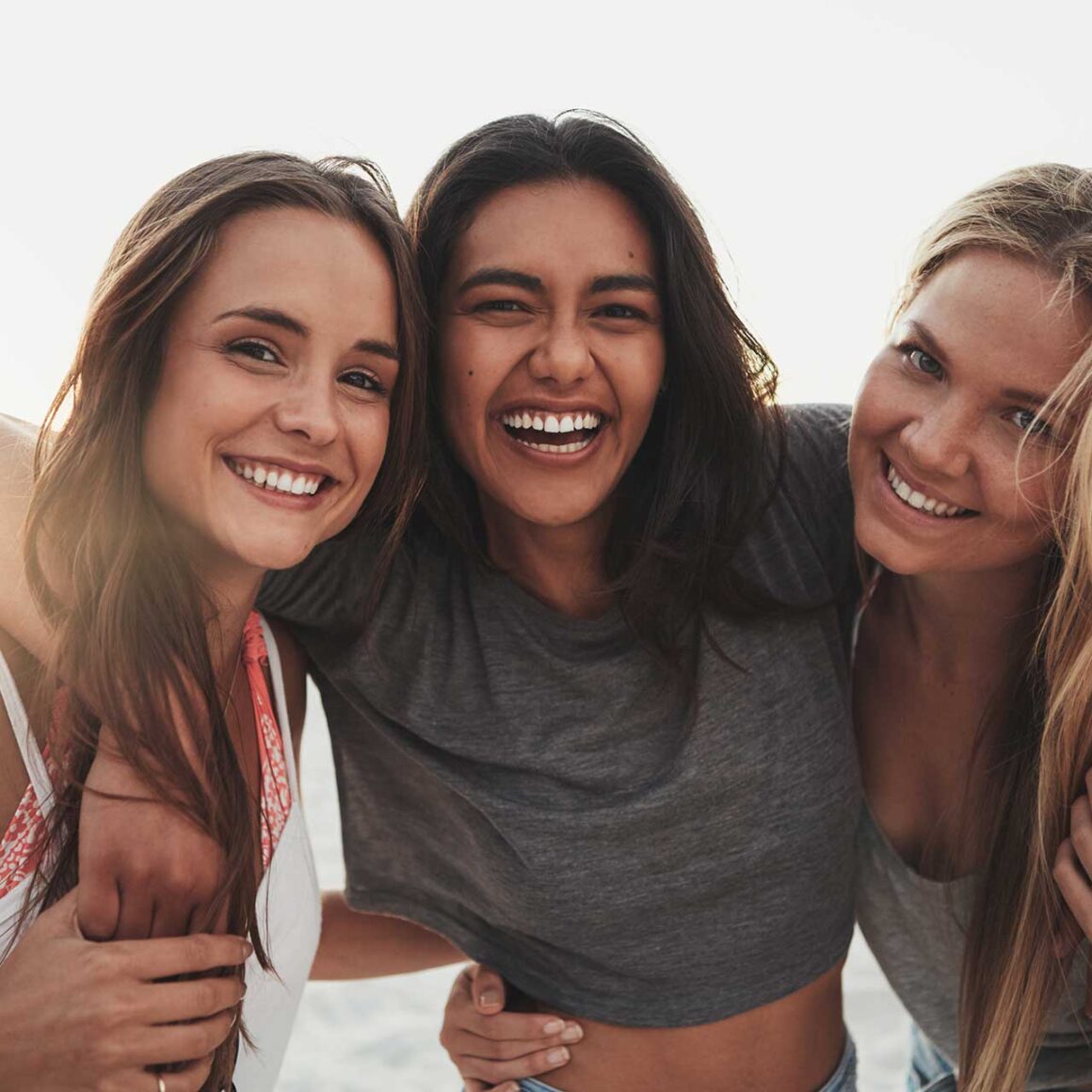 Three girlfriends spending time on the beach
