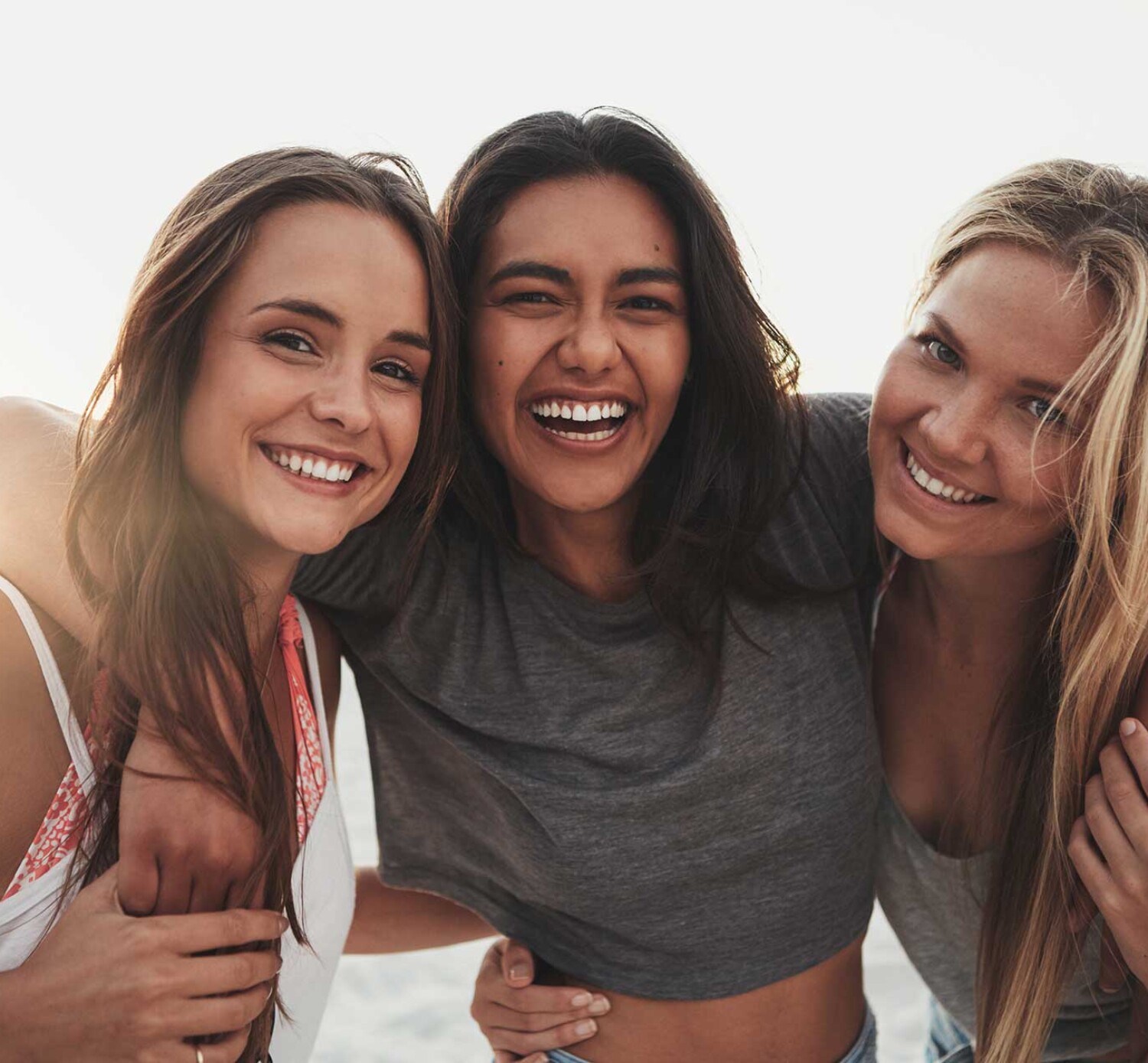 Three girlfriends spending time on the beach