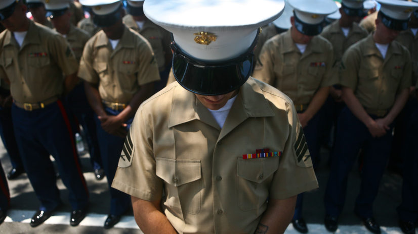 PELHAM, N. Y. - Special Purpose Marine Air Ground Task Force New York Marines bow their heads during the invocation ahead of Memorial Day ceremonies in Pelham, N.Y May 31. The Marines marched through town with sailors, retired veterans, fire fighters and police.  The Marines were on hand as part of Fleet Week New York 2010. This is the 26th year New York City has hosted the sea services for Fleet Week.